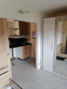 a room with a kitchen with a sink and a mirror at Appartement plein sud, Val Thorens Centre in Val Thorens