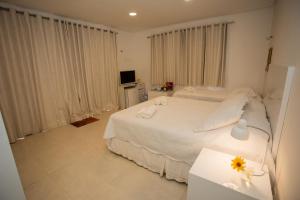 Кровать или кровати в номере Suites Amma Noronha