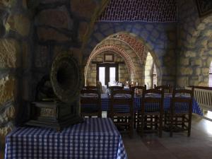 a dining room with a table and chairs in a building at Aliyah Eco-Lodge in Bawati
