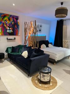 a living room with a couch and a bed at Ty-paradis in Saint-François