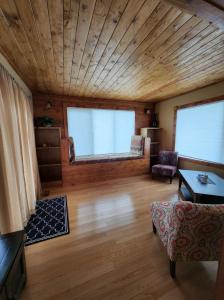 a living room with a wooden ceiling and a couch at Feel at home, Country style family house. in Magrath