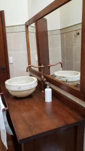 a bathroom with two sinks and a large mirror at Hostería Boutique Fuegos del Sur in Ushuaia