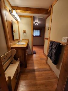 a bathroom with a sink and a mirror at Feel at home, Country style family house. in Magrath