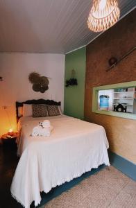 a bedroom with a bed with towels on it at Pousada Ziriguidüm in Caraíva