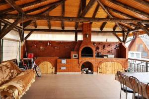 Habitación grande con pared de ladrillo y mesa. en Casa de langa rau RUCAR, en Rucăr