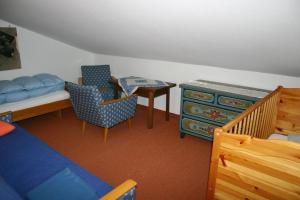 a bedroom with a bed and a table and chairs at Gästehaus Obertanner in Reit im Winkl