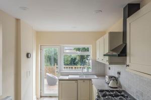 a kitchen with a sink and a stove top oven at Picton House: Charming 3 bed property in quiet location in Ramsgate +22 photos