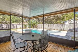 a patio with a table and chairs and a pool at Large Groups Up to 12 Guests In ground POOL in Tampa