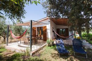 a house with a hammock in the yard at Agriturismo Fontetrilla in Orbetello