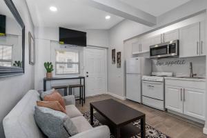 eine Küche und ein Wohnzimmer mit einem Sofa und einem Tisch in der Unterkunft South Tampa Central Location Efficiency Suite in Tampa