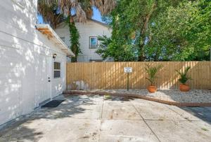 einen Zaun vor einem weißen Haus in der Unterkunft South Tampa Central Location Efficiency Suite in Tampa