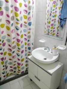 a bathroom with a sink and a shower curtain at Depto En El Centro - Dean Funes in Cordoba