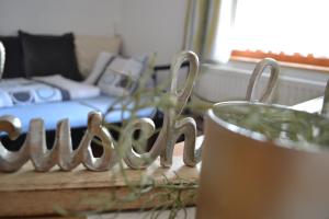 a table with a glass of beer and a bed at Appartement Thermenzeit in Längenfeld