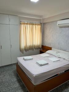 1 dormitorio con 1 cama con 2 toallas en New Point en Fortaleza