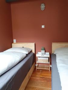 duas camas sentadas uma ao lado da outra num quarto em Gastenverblijf By ús thús em Anjum