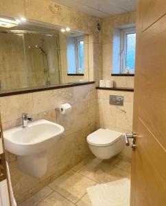 a bathroom with a sink and a toilet at Queens stay, Seaburn in Sunderland