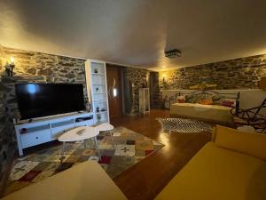 uma sala de estar com uma grande televisão de ecrã plano em Refúgio em Castelo de Paiva