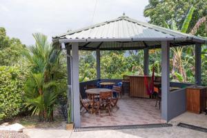 a gazebo with tables and chairs on a patio at Hospedaje RM in Villeta