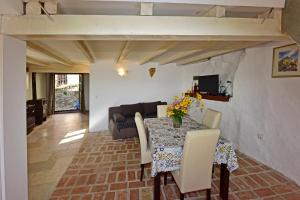 a dining room with a table and a couch at Villa Fragola in Motovun