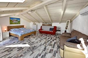 a living room with a bed and a couch at Villa Fragola in Motovun