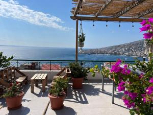 a balcony with flowers and a view of the ocean at TERRACE VIEW APARTMENTS in Sarandë