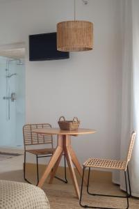 a dining room with a table and two chairs at Hostal Sa Teula in Llafranc