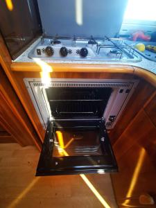 a stove with an open oven in a kitchen at Rent a BlueClassics 's Campervan AUTOSTAR in Algarve au Portugal in Portimão