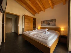 a bedroom with a large bed with two swans on it at Chalet an der Piste in Kaprun