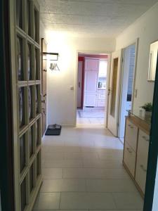 a hallway of a home with a tile floor at Schöne Große Wohnung, Terrasse, Kamin, Parkplatz, 2 Schlafzimmer in Greifswald