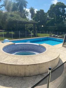 a large swimming pool with a stone circle around it at casa-quinta cerca de corrientes y santa ana in Corrientes