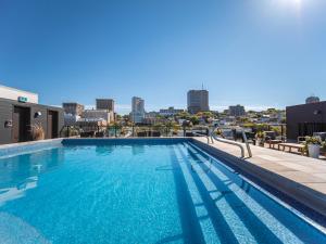 a large swimming pool on the roof of a building at Le Caïman in Quebec City