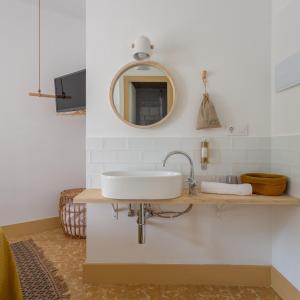 a bathroom with a sink and a mirror at Hostal Sa Teula in Llafranc