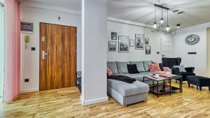 un salon avec un canapé et une table dans l'établissement Apartament Angelika G1 z Prywatną Sauną, 3 sypialniami, 2 łazienkami - 5D Apartamenty, à Świeradów-Zdrój