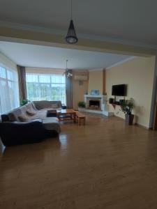 a large living room with a couch and a table at Holiday home on Lapstinskaya 17 in Tsandrypsh