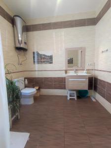 a bathroom with a sink and a toilet at Holiday home on Lapstinskaya 17 in Tsandrypsh
