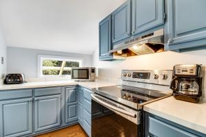 a blue kitchen with stainless steel appliances and blue cabinets at Shelter Cove 1722 in Seabrook Island