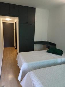a bedroom with two beds and cabinets in it at Alojamento Central - Funchal in Funchal