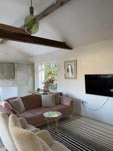 a living room with a couch and a flat screen tv at Cosy apartment with fire stove in Athlone