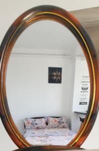 uno specchio che riflette un letto in una stanza di Studio 32 Bulevardul Oltenia a Craiova