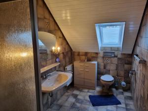 a small bathroom with a sink and a toilet at Haus Katarina in Wiesmoor