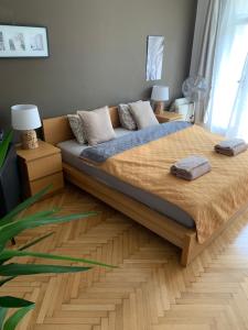 a bedroom with a large bed with a wooden frame at Anenska by Charles Bridge 2 in Prague