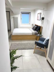 a bedroom with a bed and a couch and a chair at The Hidden Studio; Comfy & close to the Lake in Lugano +13 photos