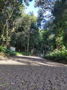 a cobblestone road in a park with trees at Vila Betânia in Porto Alegre