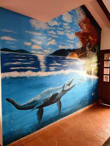a whale mural on a wall in a room at Hotel Villasaurio in Sáchica