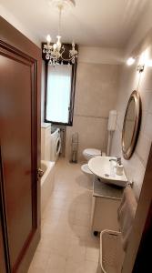 a bathroom with two toilets and a sink and a mirror at Il sole in Carpi +44 photos