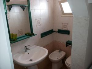 ガリポリにあるAppartamento Perla Dello Ionioのバスルーム(洗面台、トイレ、鏡付)