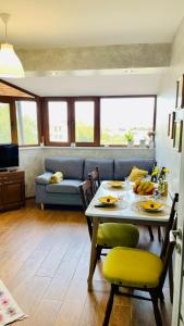 a living room with a table and a couch at PANORAMA-М in Vratsa