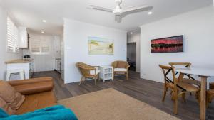 a living room with a table and a dining room at Craigmore on the Beach unit 6 in Yamba