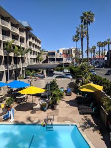 a swimming pool with umbrellas and a resort at Inn by the Sea, La Jolla in San Diego