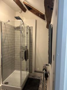 a shower in a bathroom with a glass shower stall at Abbey Cottage in Llangollen